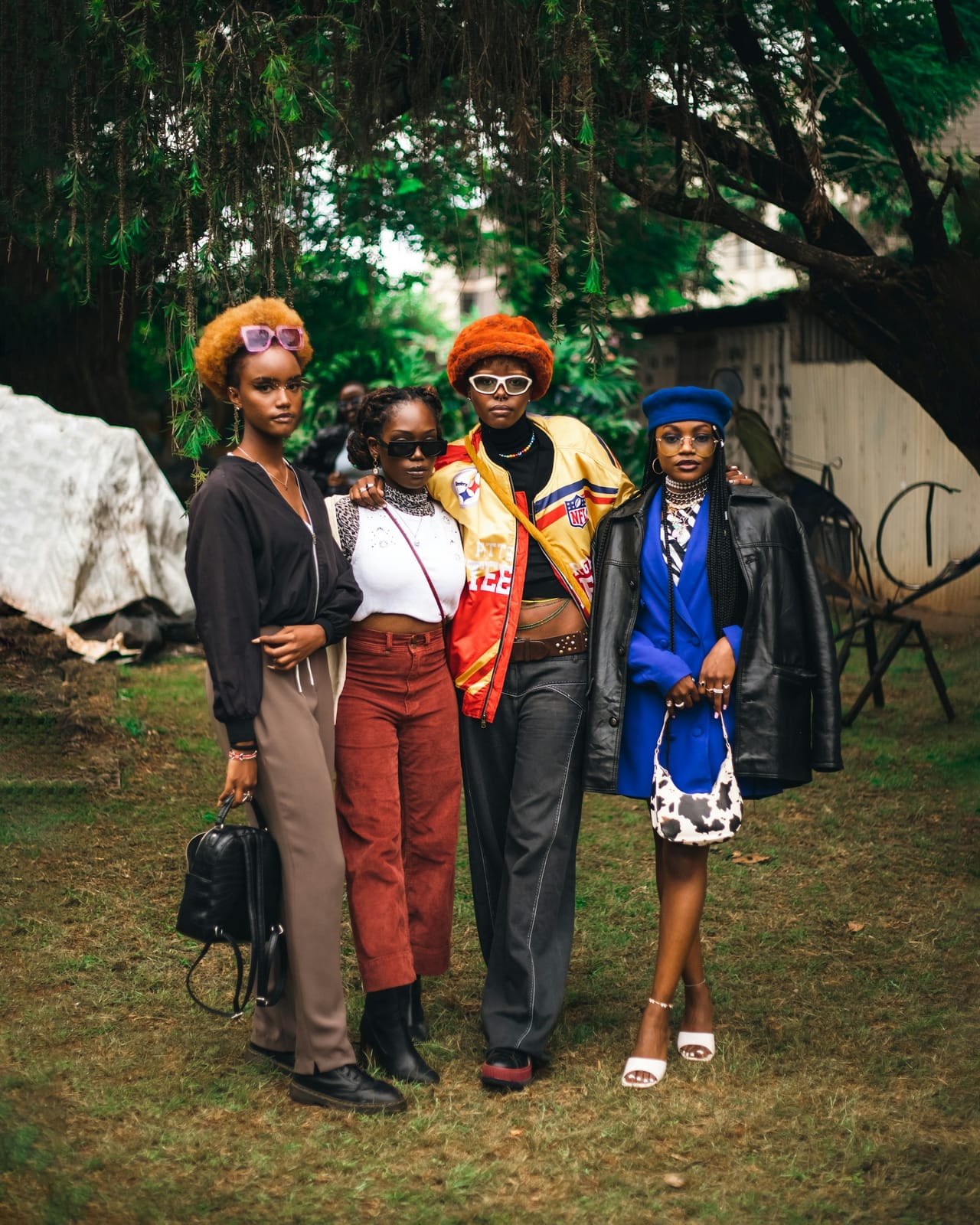 A group of friends in colourful outfits posing together.